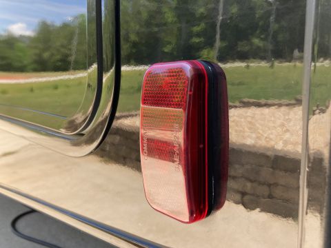 2015 Ford F-550 - A close-up view of a vehicle's taillight, showing its red and amber sections and some embossed text.