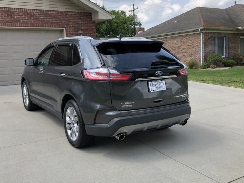 2019 Ford Everest - Rear view of a dark gray Ford Edge Titanium SUV.