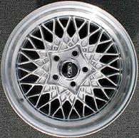 1997 Ford Crown Victoria - A single aftermarket mesh wheel is displayed against a gray carpeted surface.
