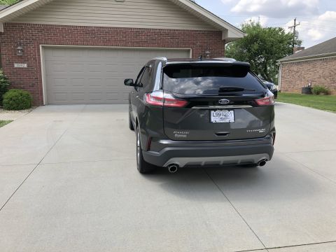 2019 Ford Everest - Rear view of a 2019 Ford Edge Titanium parked in a driveway in front of a garage.