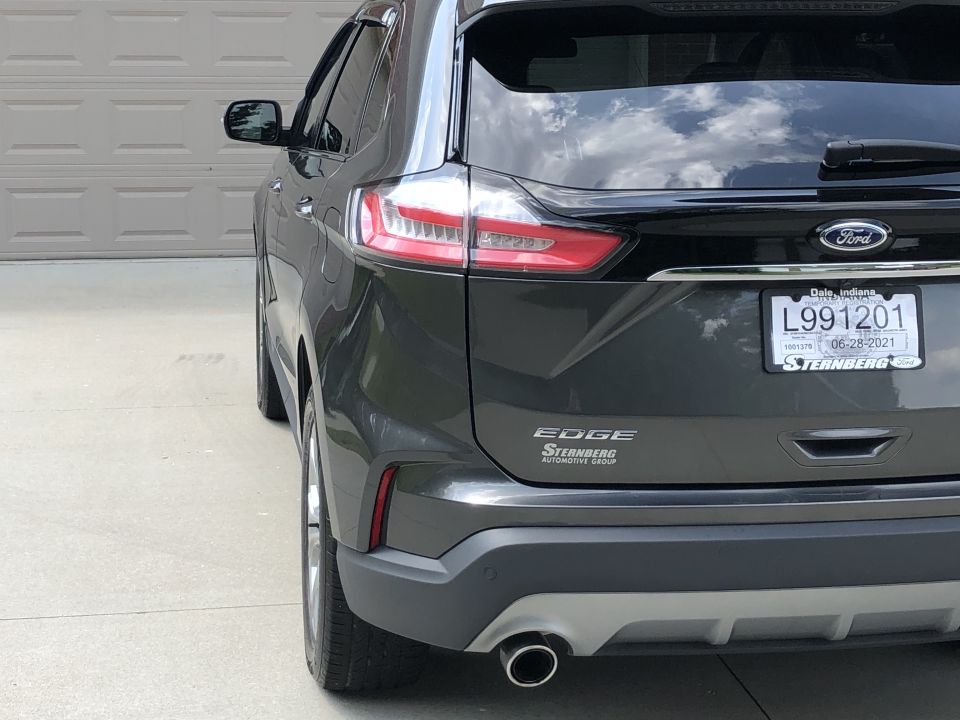 Dark gray Ford Edge SUV rear, showing taillights, bumper, exhaust, and license plate