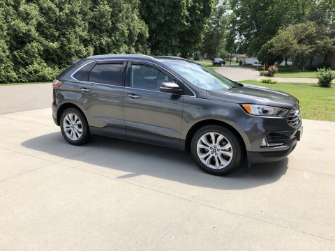 2019 Ford Everest - Gray Ford Edge SUV parked on a driveway on a sunny day.