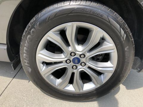 2019 Ford Everest - A close-up, low-angle shot shows the front passenger side wheel and tire of a vehicle. The tire is a Hankook Ventus S1 Noble2, and the silv…