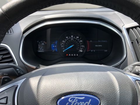 2019 Ford Everest - The image shows a close-up view of a car's dashboard, focusing on the instrument cluster and steering wheel. The digital display shows the…