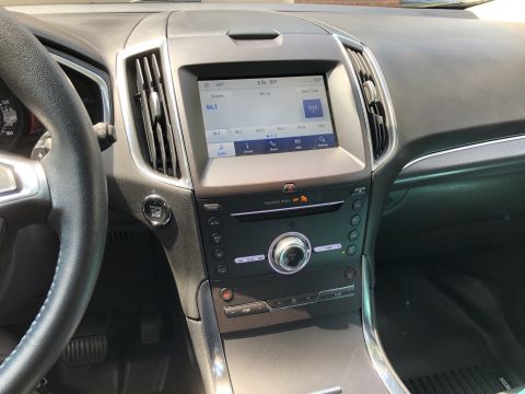 2019 Ford Everest - The interior of a modern vehicle's dashboard is shown, focusing on the center console with a touchscreen infotainment system, climate contr…