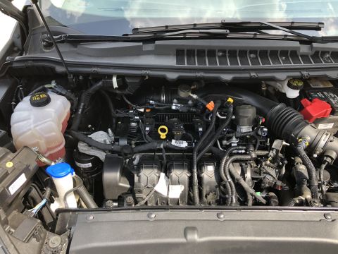 2019 Ford Everest - A close-up, top-down view of the engine bay of a modern vehicle, showing various components like the coolant reservoir, air intake, and wir…