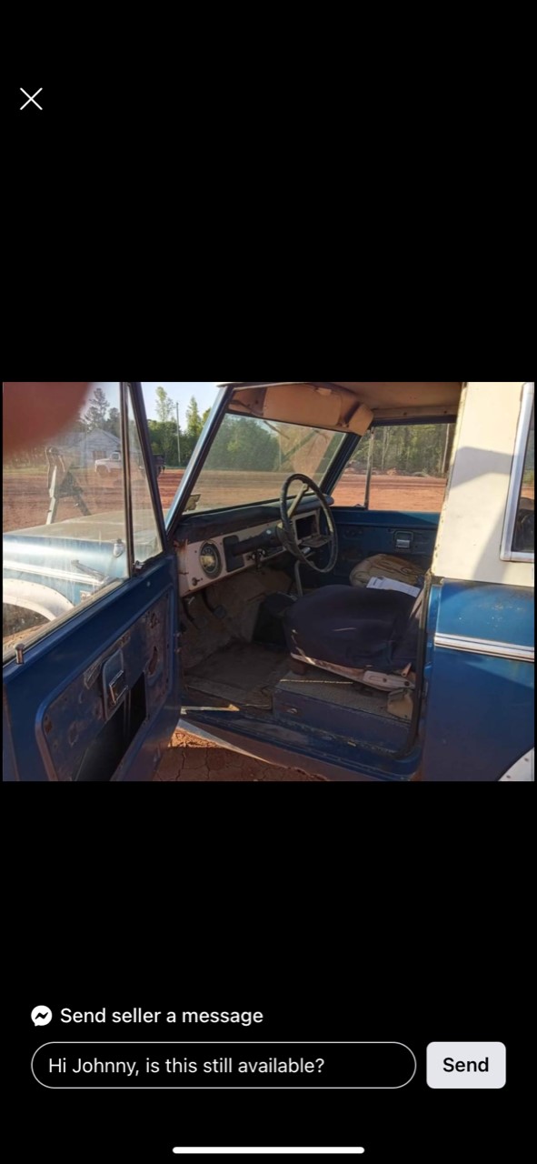 Interior of a classic blue SUV, showing dashboard, steering wheel, and seats.