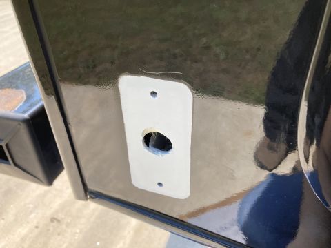 2015 Ford F-550 - A close-up view of a black vehicle's side panel shows a rectangular white patch with a hole in the center, likely a mounting plate for a co…