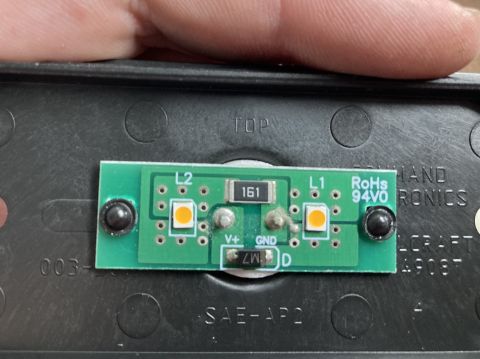 2015 Ford F-550 - A close-up view of a small green circuit board with two orange LEDs, a resistor labeled '161', and other electronic components. Text on the…