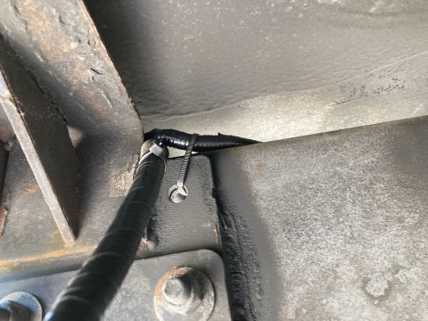 2015 Ford F-550 - Underbody wiring harness secured with zip ties to a metal frame.