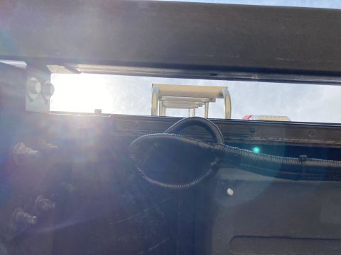 2015 Ford F-550 - View of a truck's underbody, showing a black wiring harness and a ladder against a bright sky.