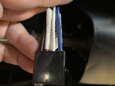 2015 Ford F-550 - A hand holds a black electrical connector with several wires leading into it. The connector has labels A, B, C, and D visible on its side.