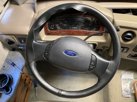 2015 Ford F-550 - Interior view of a steering wheel with a Ford logo and visible dashboard gauges.