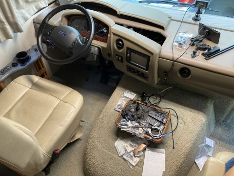 2015 Ford F-550 - The interior of an RV, showing the driver's area and a cluttered passenger side floor.