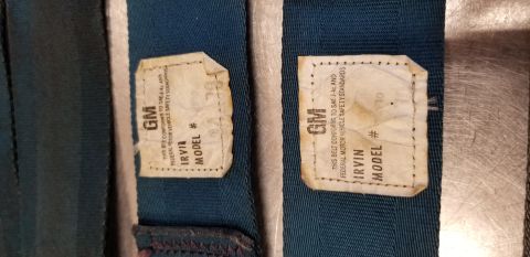 1973 Chevrolet Camaro - Close-up of two GM seatbelt labels, indicating compliance with federal motor vehicle safety standards.