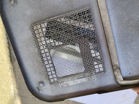2015 Ford F-550 - A metal mesh screen is attached to a vehicle component, likely to prevent insects from entering.