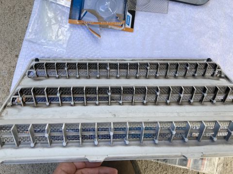 2015 Ford F-550 - A gray plastic bug screen with three rows of mesh and angled slats is shown.