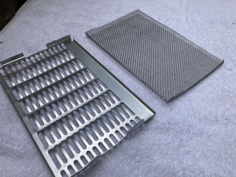 2015 Ford F-550 - Two parts of a bug screen are shown, including a metal frame with slots and a separate mesh piece.