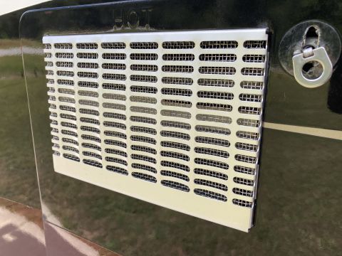 2015 Ford F-550 - A close-up view of a metal ventilation grille with a D-ring attachment point.