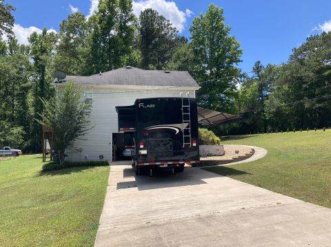 2015 Ford F-550 - RV with 'FLAIR' branding parked in a residential driveway.