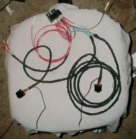 1979 Ford Bronco - Wiring harness with multiple connectors and color-coded wires, laid out for inspection.