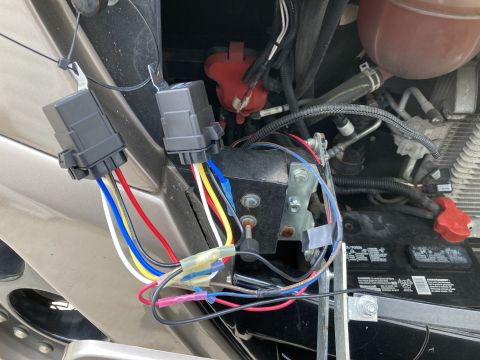 2015 Ford F-550 - Wiring harness and battery components are visible in the engine bay of a vehicle.