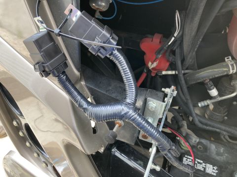 2015 Ford F-550 - This image shows a close-up view of a vehicle's electrical components, including wiring and a fuse box.