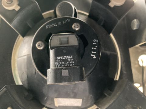 2015 Ford F-550 - Close-up of a Sylvania HB3 U 9005 bulb assembly, showing manufacturing details.