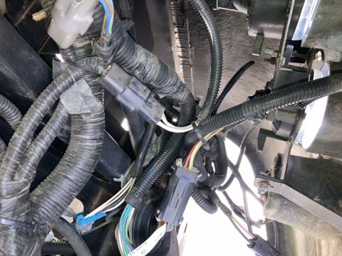 2015 Ford F-550 - Close-up view of a complex wiring harness with various connectors and protective tubing.