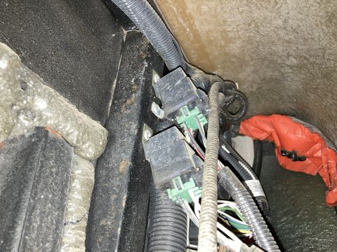 2015 Ford F-550 - Vehicle wiring harness and relays, possibly from a Ford F-550, with orange protective wrap visible.