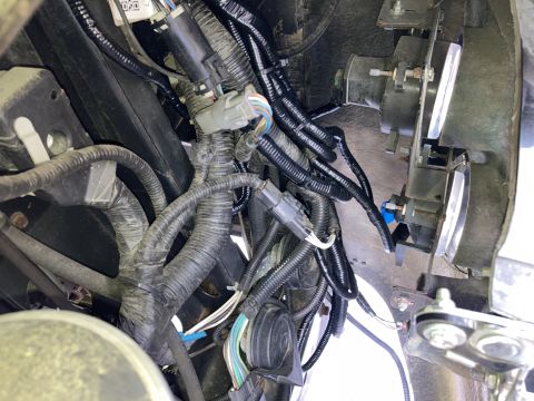 2015 Ford F-550 - Close-up view of a vehicle's wiring harness and headlight assembly.