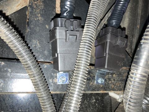 2015 Ford F-550 - Close-up view of electrical connectors and wiring harnesses, likely part of a vehicle's electrical system.