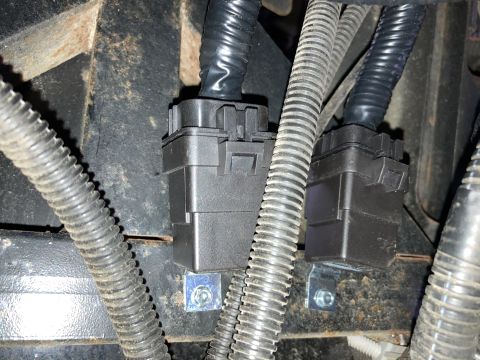 2015 Ford F-550 - Close-up view of electrical connectors and wiring harnesses, likely part of a vehicle's lighting system.