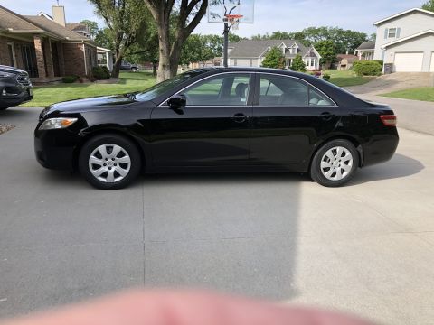 2011 Toyota Camry - Side view of a black 2011 Toyota Camry sedan parked in a driveway.