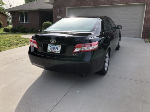 2011 Toyota Camry - Rear view of a black Toyota Camry parked on a concrete driveway.