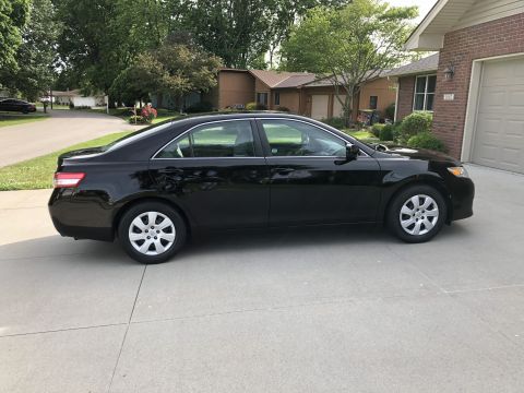 2011 Toyota Camry - Side profile of a black 2011 Toyota Camry sedan parked in a driveway.