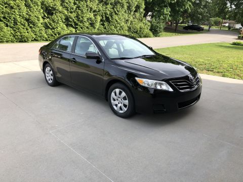 2011 Toyota Camry - Black Toyota Camry sedan with a distinctive grille design, indicating a model year prior to 2011.