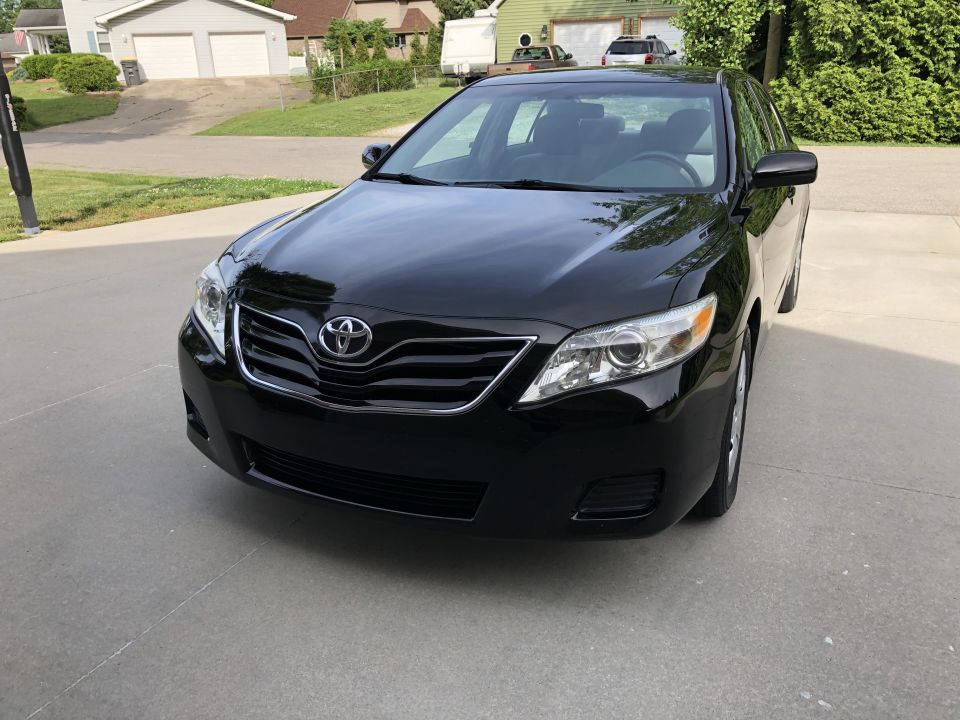 Front view of a black 2011 Toyota Camry parked in a driveway