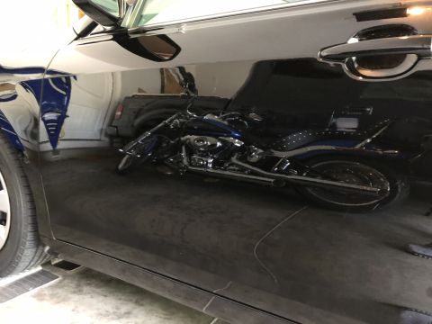 2011 Toyota Camry - A reflection of a motorcycle is visible on the glossy surface of a dark-colored vehicle.