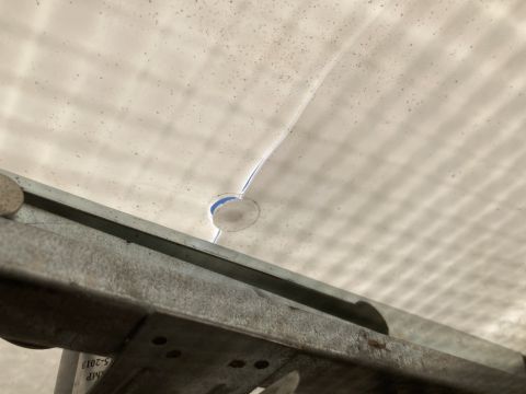 2015 Ford F-550 - A vent fan hole is visible in the ceiling, with a metal support beam below that has a date stamp.