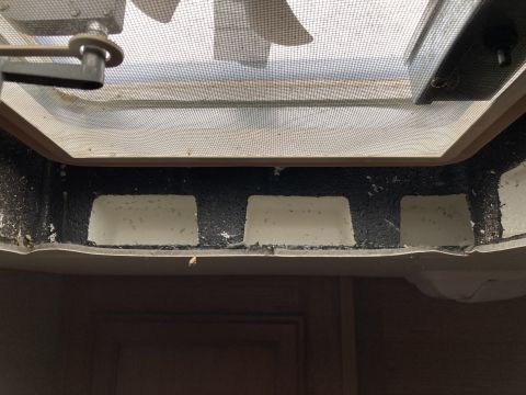 2015 Ford F-550 - Close-up view of the interior of an RV vent fan, showing the screen and mechanism.