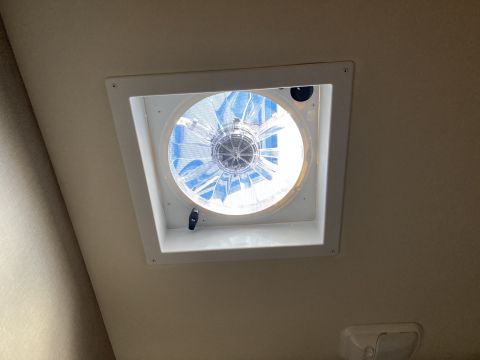 2015 Ford F-550 - A white ceiling-mounted fan with blue blades is visible in a vehicle's interior. The fan is installed in a square white housing with visibl…