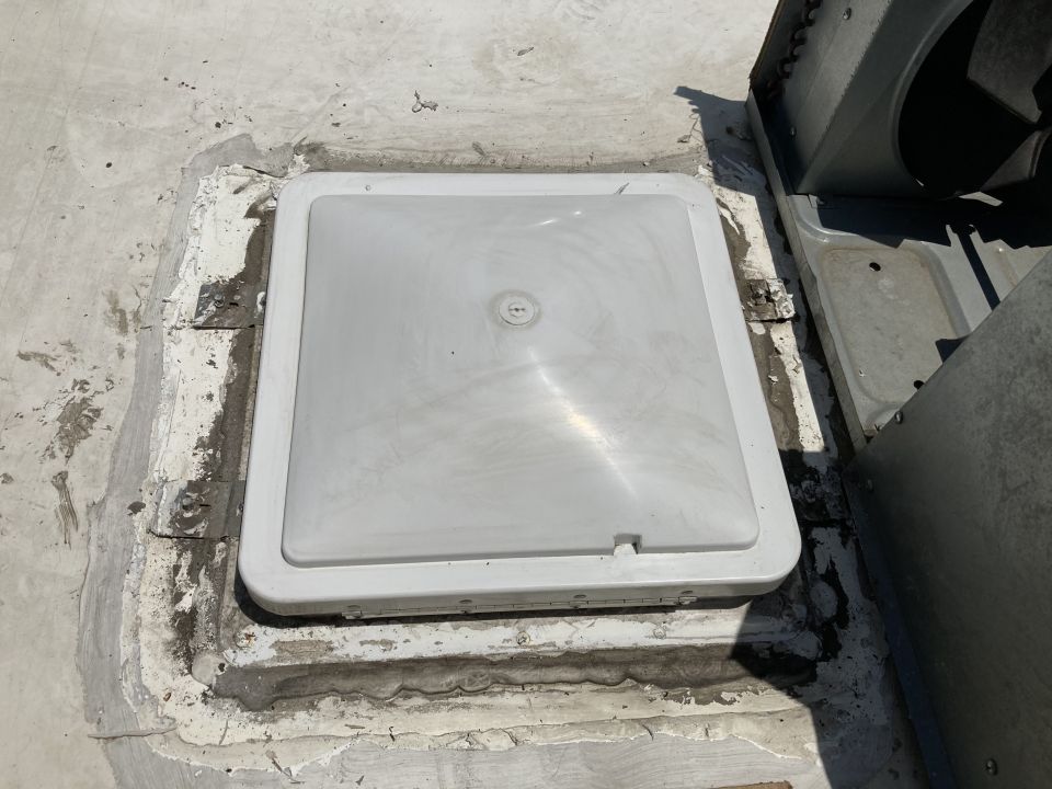 White plastic vent cover on a flat roof