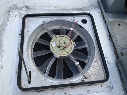 2015 Ford F-550 - A close-up view of a roof vent fan, likely for an RV or camper, showing the fan blades, motor housing, and wiring. The vent is installed in…