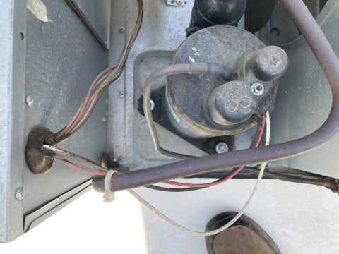 2015 Ford F-550 - This is a close-up view of the internal components of an air conditioning unit, showing electrical wiring, a compressor, and metal casing.…