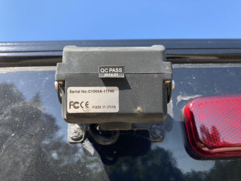 2015 Ford F-550 - Identification sticker on a backup-camera housing showing serial number and FCC/CE compliance marks.