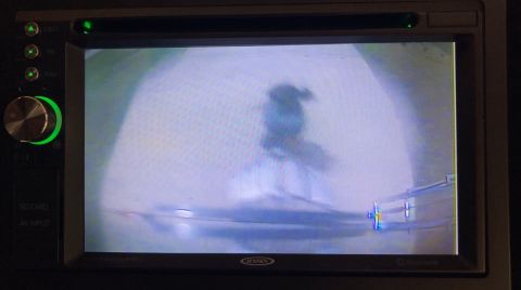 2015 Ford F-550 - Backup camera display shows a person walking on a sidewalk.