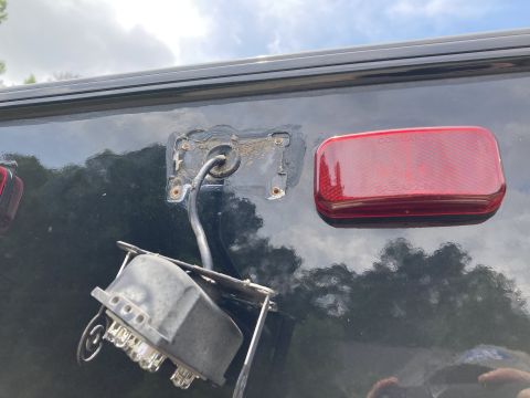 2015 Ford F-550 - The trailer wiring harness is detached from the vehicle, showing exposed connectors and a red taillight.