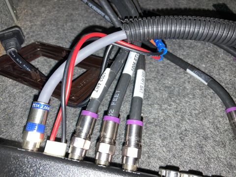 2015 Ford F-550 - A close-up view shows multiple coaxial cables with various labels and connectors, some with purple and blue bands, connected to a surface.…