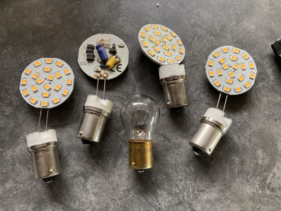 Various LED and incandescent light bulbs on a dark surface
